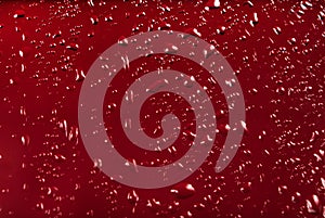 Drops of water on a red color background