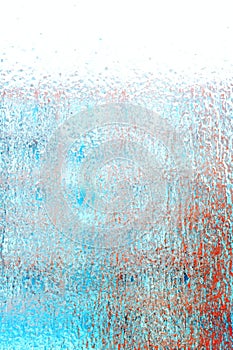 Drops of water on a transparent surface. Abstract background and texture for design, frozen glass. Ice layer on the