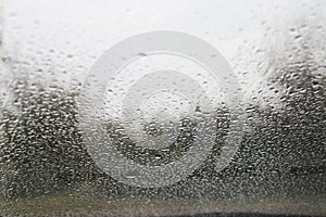 Drops of water on the windshield of a car.