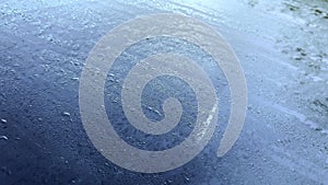 Drops of water on the windshield of a car. Melted frost in the morning on the car