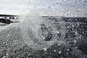 Drops and wave on the breakwater in Ustka