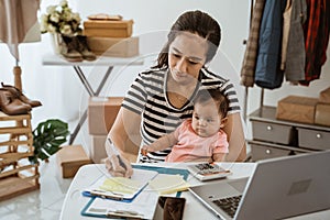 Dropshipping business owner working in her office. working mother