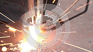 Dross sparks scatter during plasma cutting process closeup