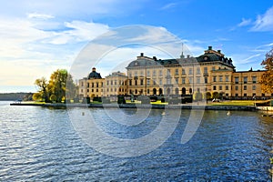 Drottningholm Palace, Swedens royal residence behind lake under blue skies