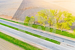 Drought concept. Road running along farmlands, aerial landscape