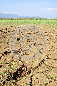 Drought land against a blue sky with trail