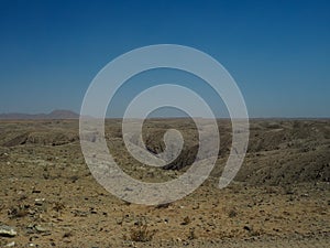 Drought rock desert valley panorama landscape view looking like Mars surface scene with blue sky background