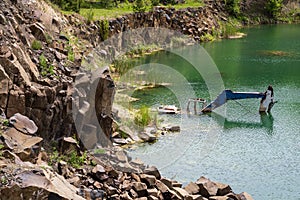 Drowned in flooded basalt quarry excavator