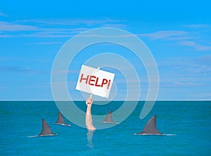 Drowning depressed man with help sign surrounded by sharks