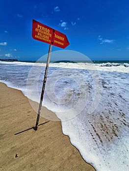 Drowning hazard sign on the beach in Porto de Galinhas, Pernambuco, Brazil