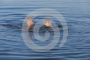 Drowning man reaching for help in sea, closeup