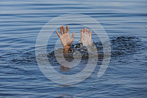 Drowning man reaching for help in sea, closeup