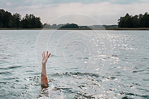 Drowning man. Sticking hand out of water