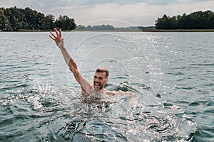 Drowning man. Sticking hand out of water