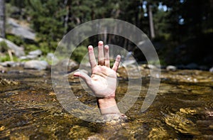 Drowning man. Sticking hand out of water