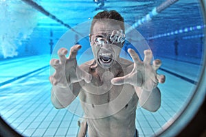 Drowning man underwater diver