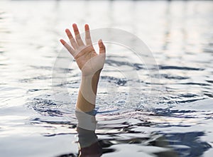 Drowning victims, Hand of drowning woman needing help. photo