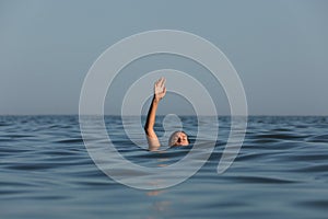 Drowning woman reaching for help