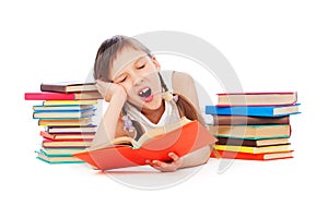 Drowsy little girl with books