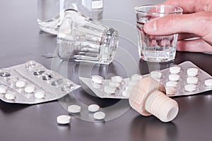 Drug abuse: Close up of pills and alcohol on a grey table