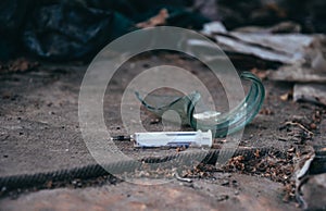 Old abandoned house and used plastic syringes. The problem of drug addiction in society