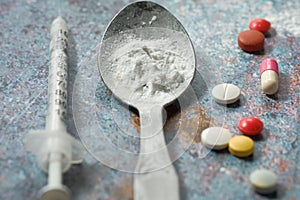 Drug addiction concept with heroine packet and syringe on black backgrund photo