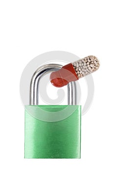 Drug capsule red and white trapped in a blue metal padlock on white background copy text