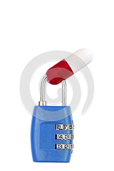 Drug capsule red and white trapped in a blue metal padlock on white background copy text