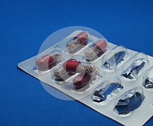 The drug in capsules. Capsules lie in plastic transparent packaging