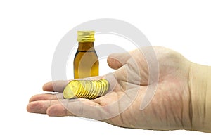 drug opaque glass bottles and stack of coin handle by man hand