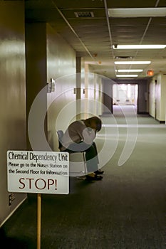 Drug user waits for help in chemical dependency unit of local hospital.