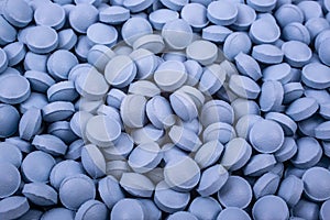 Drugs, painkillers, colds and other medicines. blue pills lie on table