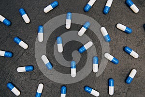 Drugs pills capsules on dark background abstract concept