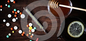 Drugs and pills on a wooden table. Various means to prevent cold