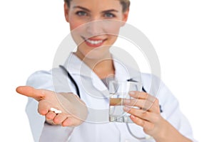 Drugs and water glass held by nurse