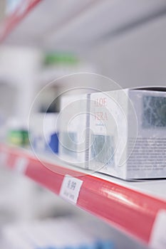 Drugstore shelves stocked with various medicinal products and aloe vera cream ready for clients