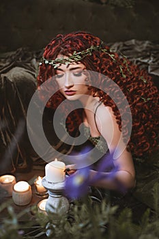 Druid woman sitting with candles