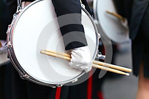 Drum with a hand and drumsticks on parade