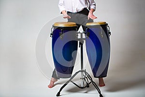 Drum. Hands of a musician playing on bongs. Performers playing bongo drums. Close up of musician hand playing bongos