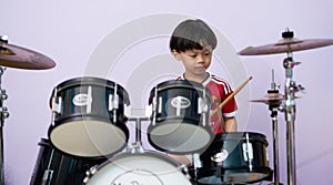Drum kit or drum set with boy playing background