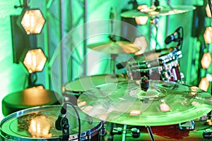 Drum kit on stage. Close-up of plate, drums, sticks, in background scene spotlights