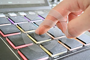 Drum machine pads being hit by hand / fingers