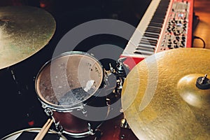 Drum set in dramatic light on a black background.