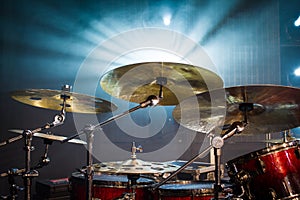 drum set on stage and light background; empty stage with instruments ready for performance