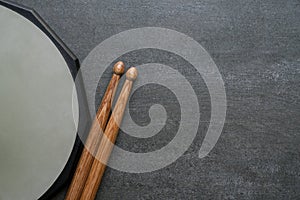 Drum stick and drum pad on black table background