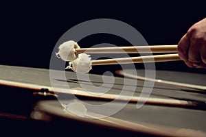 Drum sticks hitting the timpani