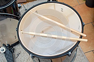 Drum-sticks lying on a drum