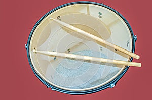 Drum-sticks lying on a drum