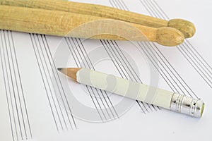 Drum sticks, a pencil and a music sheet on a desk in a classroom. Empty copy space