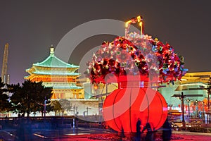 The drum tower and a basket of flowers in city center at night photo